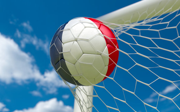 France flag and soccer ball in goal net