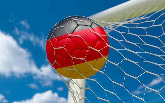 Germany flag and soccer ball in goal net