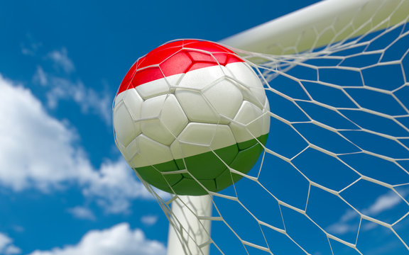 Hungary flag and soccer ball in goal net