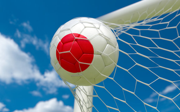 Japan flag and soccer ball in goal net
