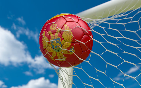 Montenegro flag and soccer ball in goal net