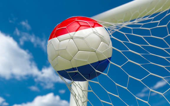 Netherlands flag and soccer ball in goal net