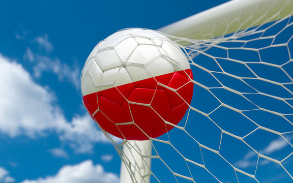 Poland flag and soccer ball in goal net
