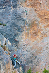 Fototapeta premium Female climber on a cliff