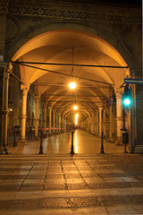 Fototapeta na wymiar Bologna porticos, night street life