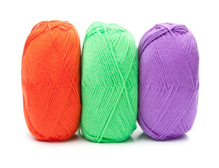 stack of yarn skeins in red, green, purple colors on white backg