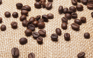 Coffee beans on burlap background
