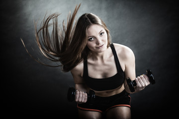 Fitness girl training shoulder muscles lifting dumbbells