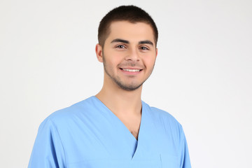 Young male doctor isolated on white