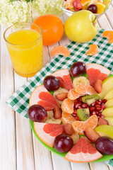 Fototapeta na wymiar Sweet fresh fruits on plate on table close-up