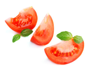 Slices of fresh tomato with basil, isolated on white