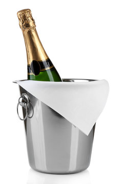 Bottle of champagne in pail isolated on white