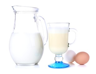 Eggnog with milk and eggs isolated on white