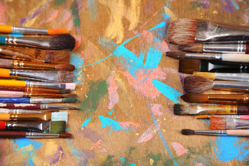 Obraz premium Brushes on multicolor wooden background