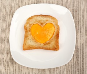 Scrambled eggs with bread on plate, on color napkin