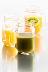 Glass jars of fresh tropical fruit juice