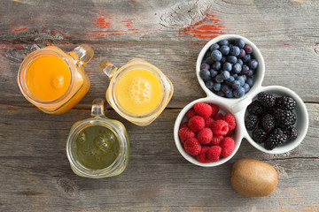 Fresh fruit juice with a dish of mixed berries