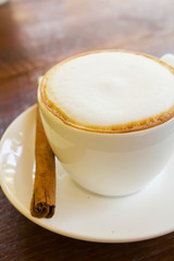 Late coffee with cinnamon stick.