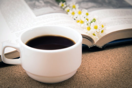 A Cup of coffee and a book.