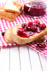 Delicious toast with jam on table close-up
