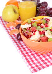 Sweet fresh fruits in bowl on table close-up