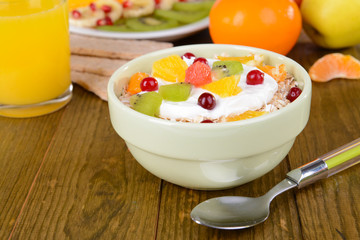 Delicious oatmeal with fruit in bowl on table close-up