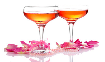 Composition with pink sparkle wine in glasses and  rose petals