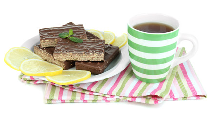 Cup of tea and sweets isolated on white