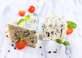 Tasty blue cheese with tomatoes, basil and spices