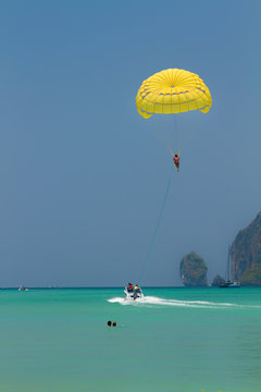 Parachute surfer being hauled by a motorboat in Thailand