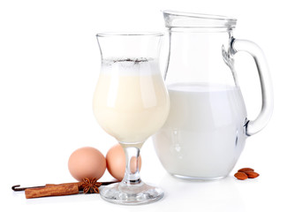 Eggnog with milk and eggs isolated on white