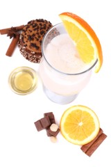 Eggnog with spices and orange isolated on white