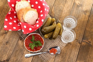 Composition with glass of vodka and marinated mushrooms,