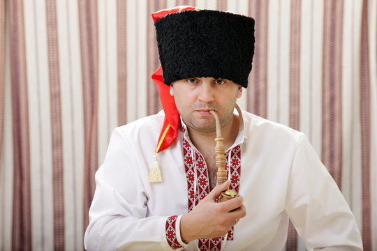 Ukrainian Cossack smokes a pipe with tobacco