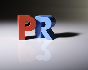 Multicolored word PR made of wood.