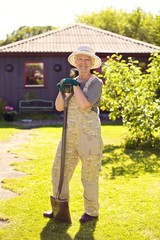 Active senior woman with gardening tools