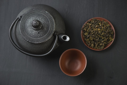 Above view of asian teapot and ceramic tableware with green tea