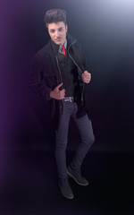 Fototapeta na wymiar Fashion young man in jeans and jacket