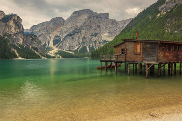 Hut on Braies Lake in Dolomiti mountains and Seekofel in backgro