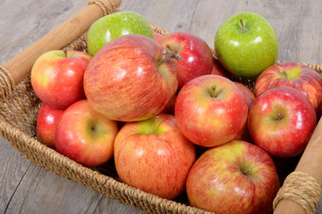 Naklejka na ściany i meble different apples in a wicker basket
