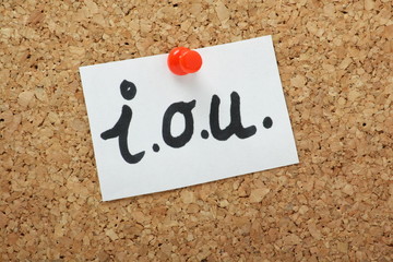 I.O.U note pinned to a cork notice board