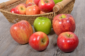 Naklejka na ściany i meble different apples in a wicker basket