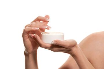Woman's hand with jar of body lotion
