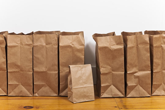 A row of brown paper bags