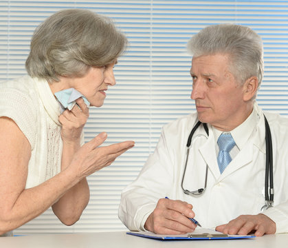 Aged doctor with old patient