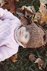 Very cheerful child having fun while tossing up leaves