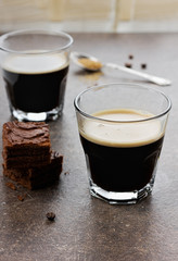 Glass of espresso with chocolate cake