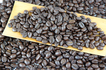 Coffee beans in bamboo dish.