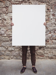 Man holding blank poster