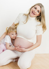 little girl with her pregnant mother